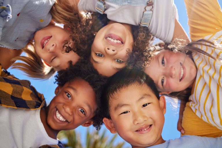 Group of multi-race kids smiling together as a team